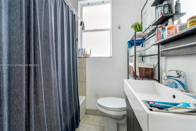 full bathroom featuring sink, tile patterned flooring, shower / tub combo with curtain, and toilet