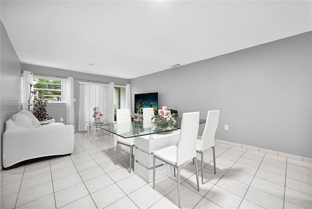 dining area featuring light tile patterned floors