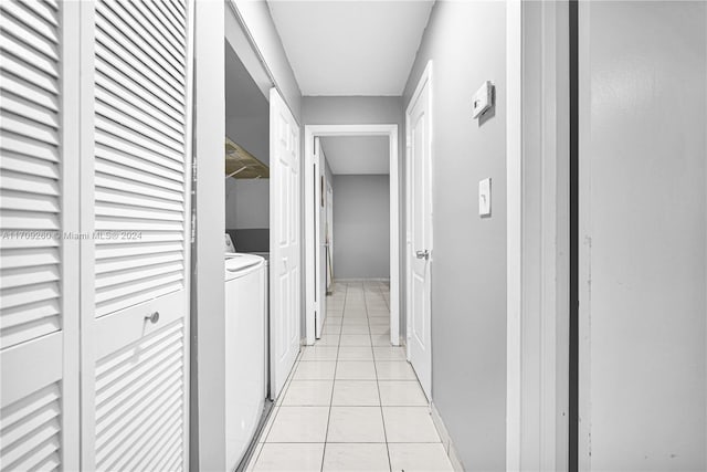 corridor featuring washer and clothes dryer and light tile patterned flooring