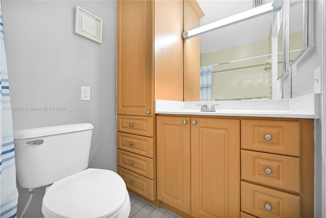 bathroom with tile patterned floors, vanity, and toilet