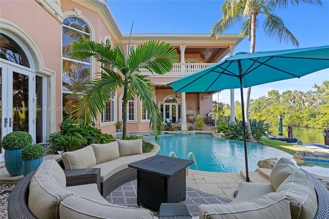 view of swimming pool featuring an outdoor living space, french doors, and a patio area