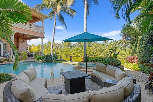 view of pool featuring an in ground hot tub, a patio, an outdoor hangout area, and ceiling fan