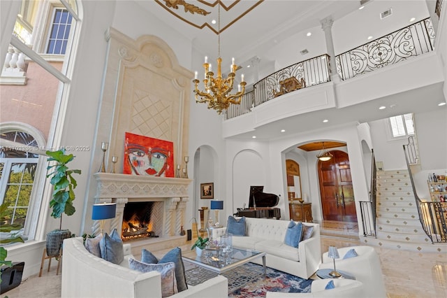 living room with an inviting chandelier and a towering ceiling