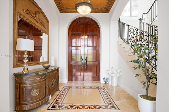 foyer featuring ornamental molding