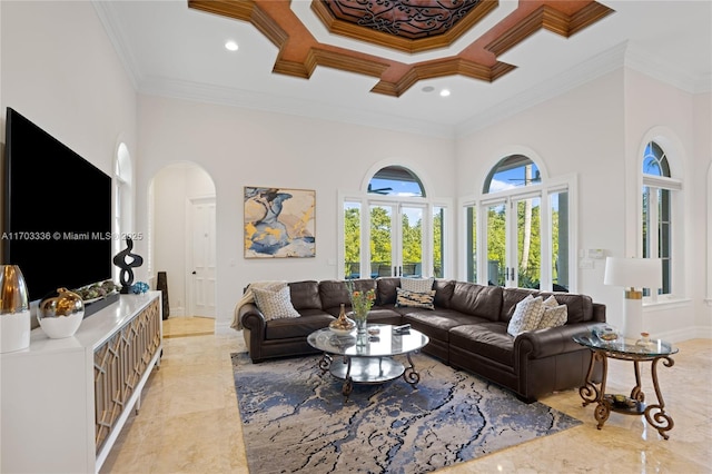 living room with a towering ceiling and ornamental molding