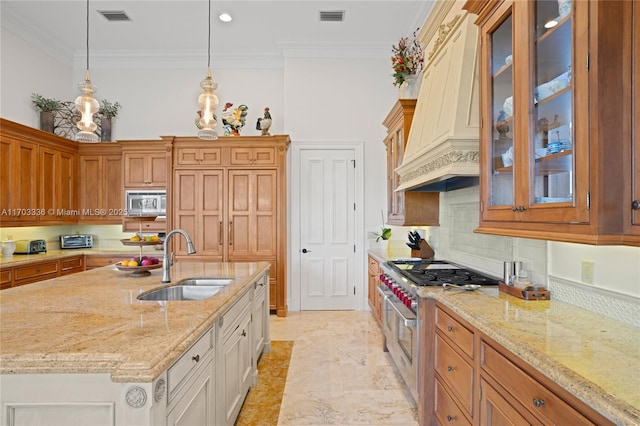 kitchen with pendant lighting, sink, appliances with stainless steel finishes, white cabinets, and custom exhaust hood