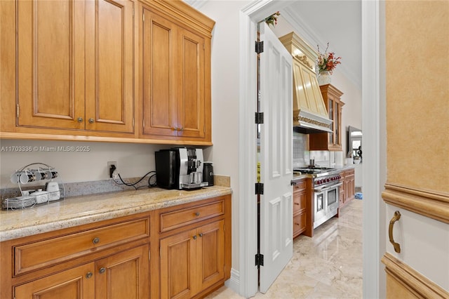 kitchen featuring tasteful backsplash, range with two ovens, custom exhaust hood, light stone counters, and crown molding