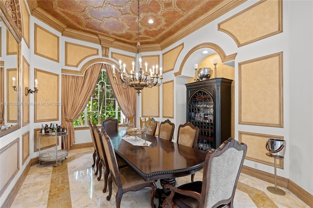 dining space with ornamental molding, a towering ceiling, and a chandelier