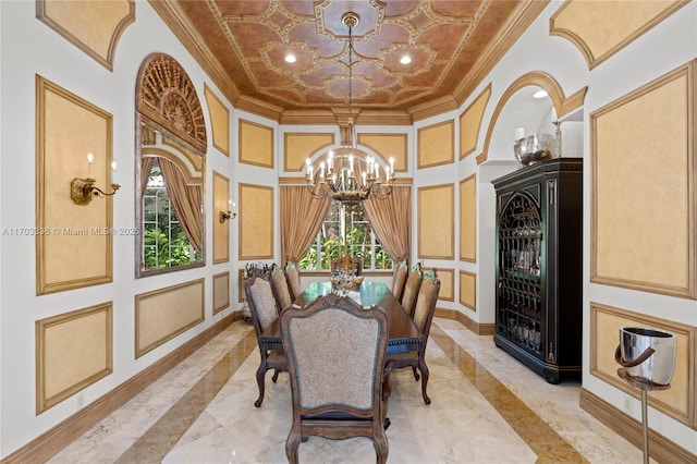 dining room featuring ornamental molding, a chandelier, and a high ceiling