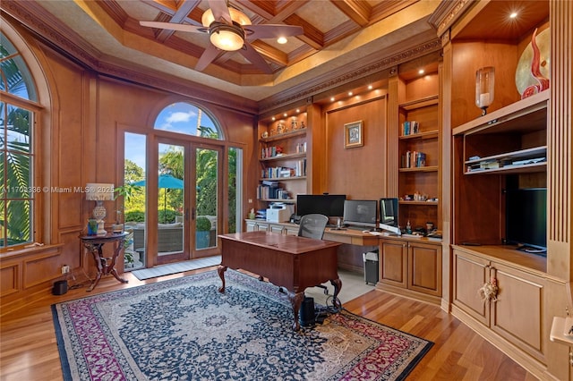 office featuring ornamental molding, coffered ceiling, light wood-type flooring, and built in shelves