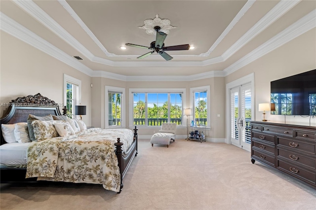 bedroom featuring crown molding, light carpet, access to exterior, and a tray ceiling