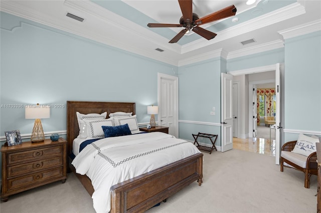 carpeted bedroom with ornamental molding, a raised ceiling, and ceiling fan