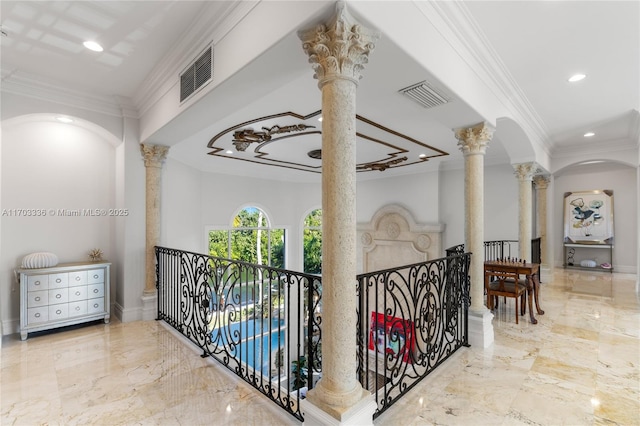 corridor with crown molding and ornate columns