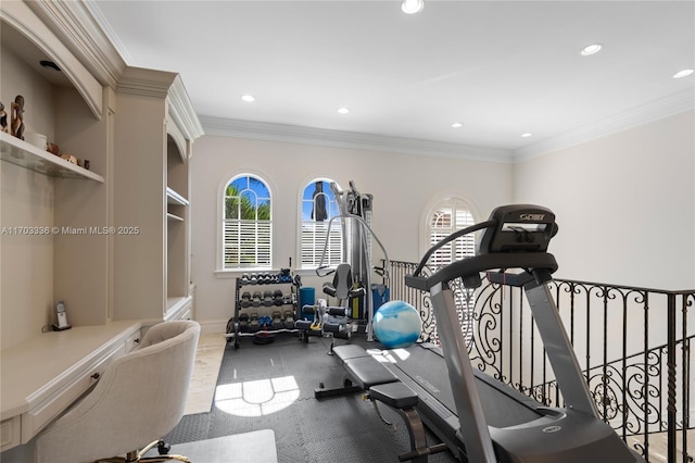 workout room featuring ornamental molding