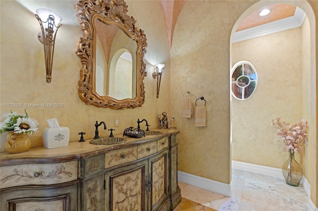 bathroom featuring ornamental molding and vanity