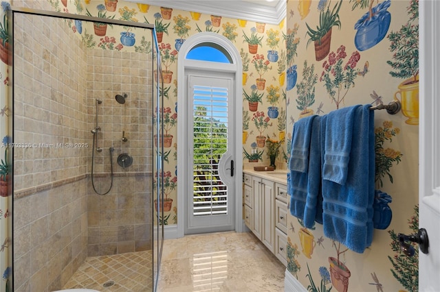 bathroom with ornamental molding, vanity, and a tile shower