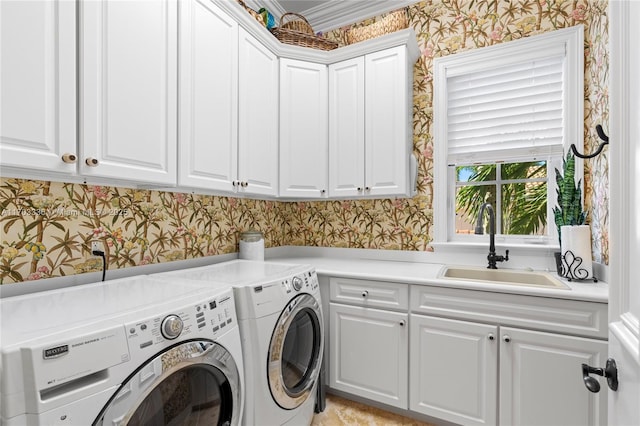 laundry area featuring sink, cabinets, and washing machine and clothes dryer