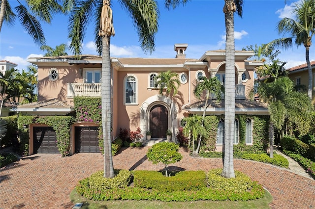 view of front of house featuring a garage and a balcony