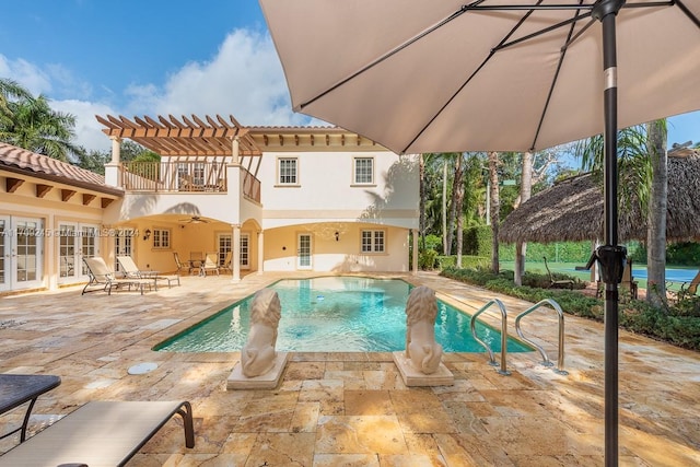 view of pool featuring french doors, ceiling fan, and a patio area