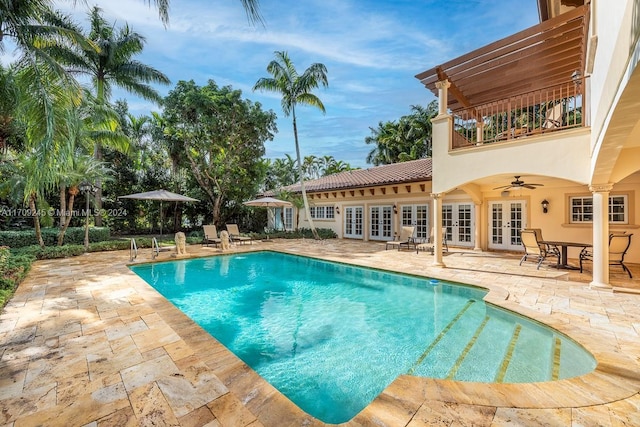 view of pool featuring a patio area, ceiling fan, and french doors