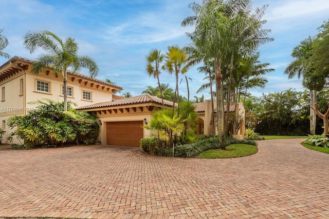 mediterranean / spanish house featuring a garage