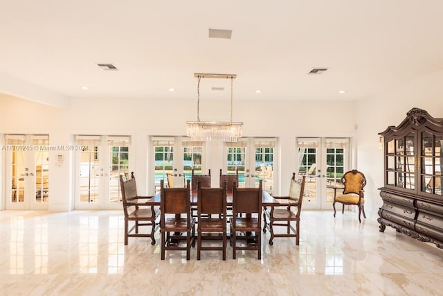 dining room featuring a notable chandelier and french doors