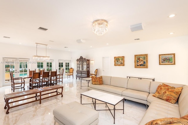 living room featuring french doors and an inviting chandelier