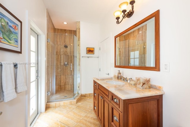 bathroom featuring tile patterned flooring, vanity, and a shower with door