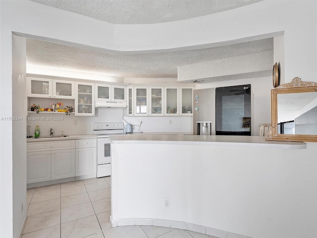 kitchen featuring sink, white cabinets, white electric stove, a textured ceiling, and light tile patterned floors