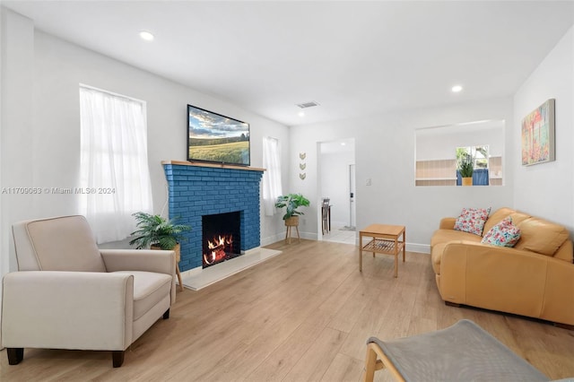 living room featuring a fireplace and light hardwood / wood-style flooring