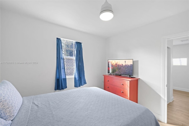 bedroom featuring wood-type flooring and multiple windows