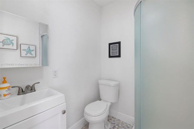 bathroom featuring tile patterned floors, vanity, and toilet