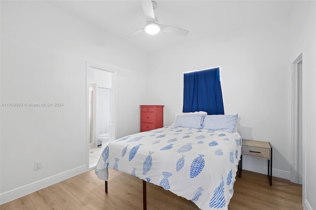 bedroom with hardwood / wood-style flooring, ensuite bath, and ceiling fan