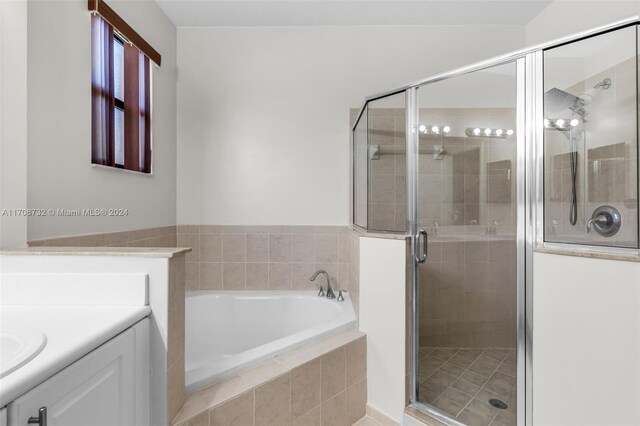 bathroom with plus walk in shower and vanity