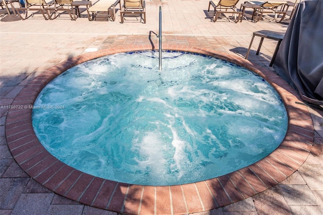 view of swimming pool with a community hot tub