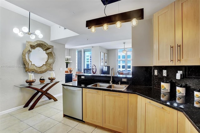 kitchen featuring light brown cabinetry, sink, and dishwasher