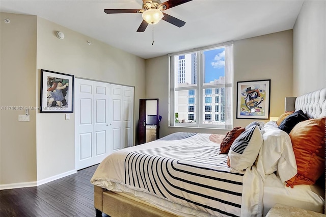 bedroom with dark hardwood / wood-style flooring, a closet, and ceiling fan