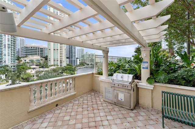 view of patio featuring a pergola, grilling area, and an outdoor kitchen