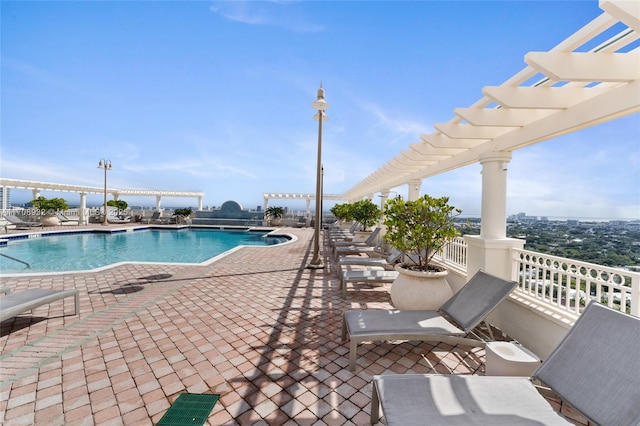 view of swimming pool featuring a pergola and a patio area