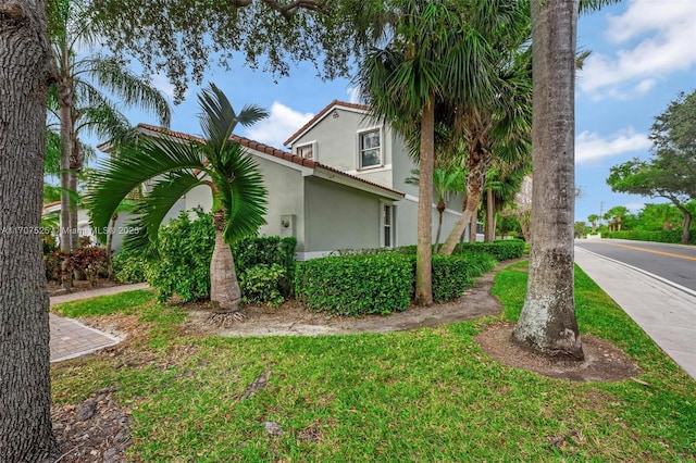 view of side of property with a yard