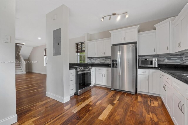 kitchen with white cabinetry, stainless steel appliances, and electric panel