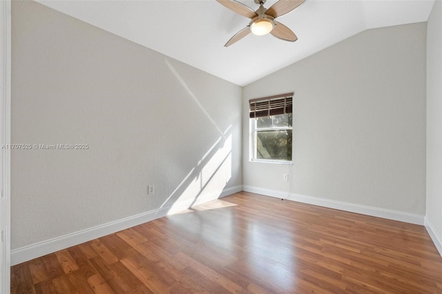 unfurnished room featuring hardwood / wood-style flooring, vaulted ceiling, and ceiling fan