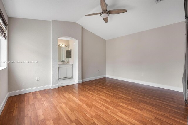 spare room featuring ceiling fan, lofted ceiling, and hardwood / wood-style floors