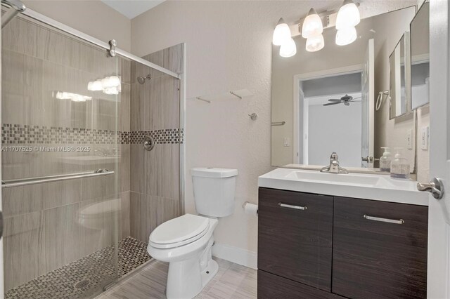 bathroom with vanity, an enclosed shower, tile patterned floors, and toilet