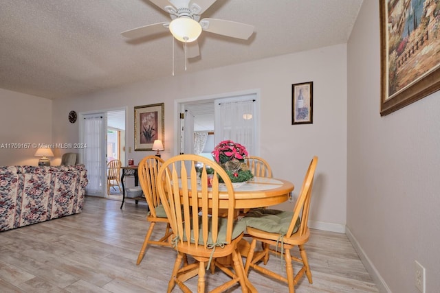 dining space featuring a textured ceiling, light hardwood / wood-style flooring, and ceiling fan