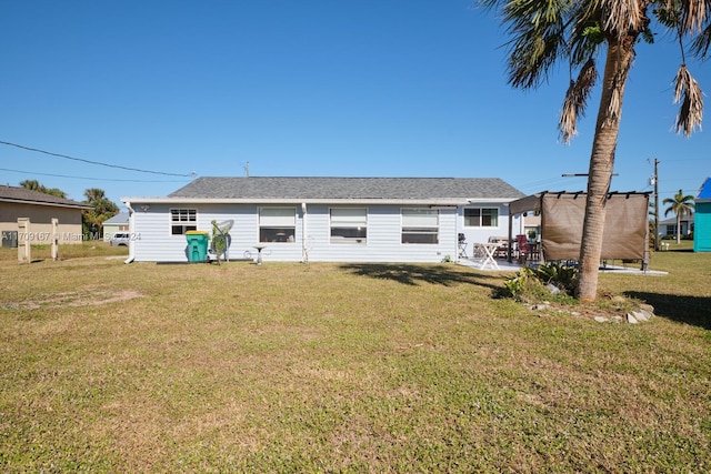 rear view of property with a yard