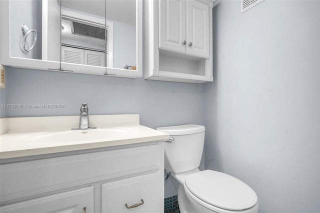 bathroom with toilet and vanity