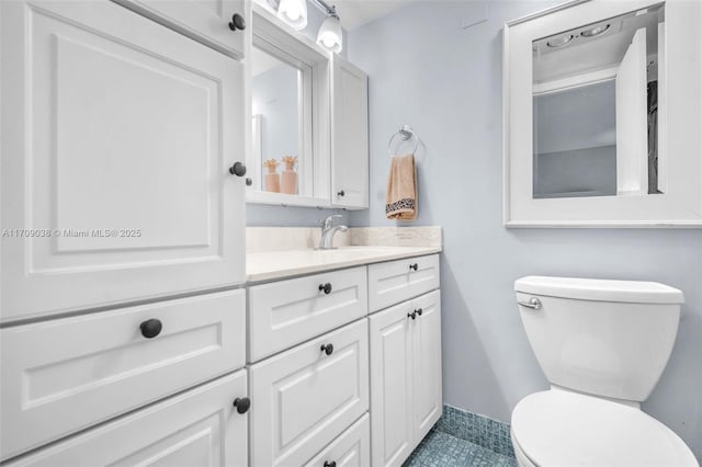 bathroom featuring toilet, tile patterned floors, and vanity