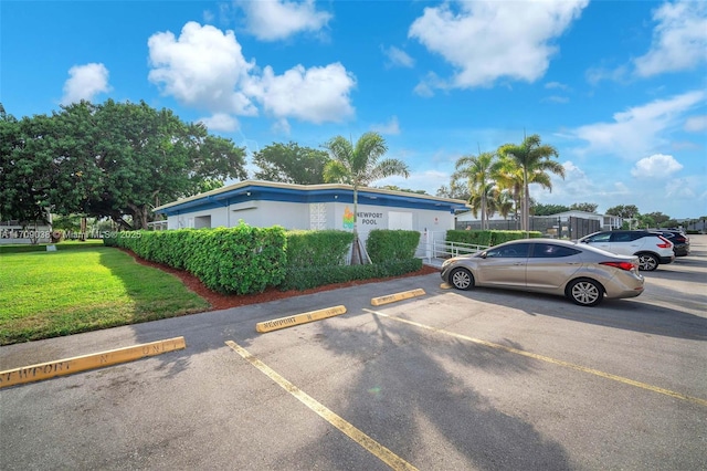 view of car parking with a lawn