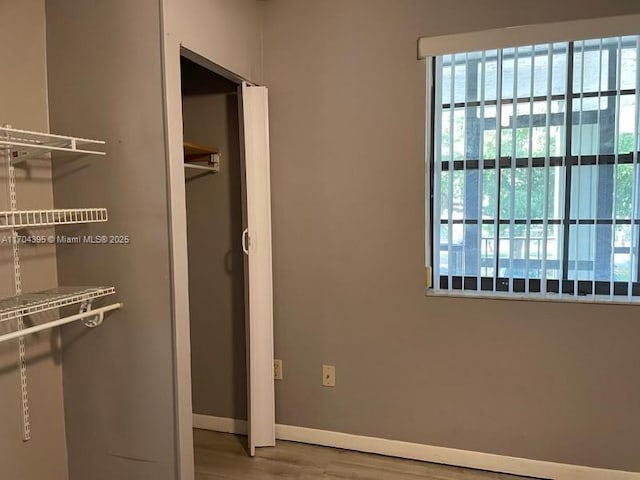 unfurnished bedroom featuring hardwood / wood-style flooring